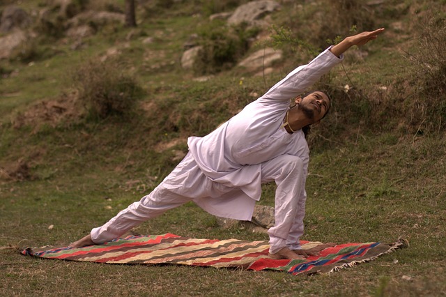 Person practicing grounding meditation exercise outdoors surrounded by nature